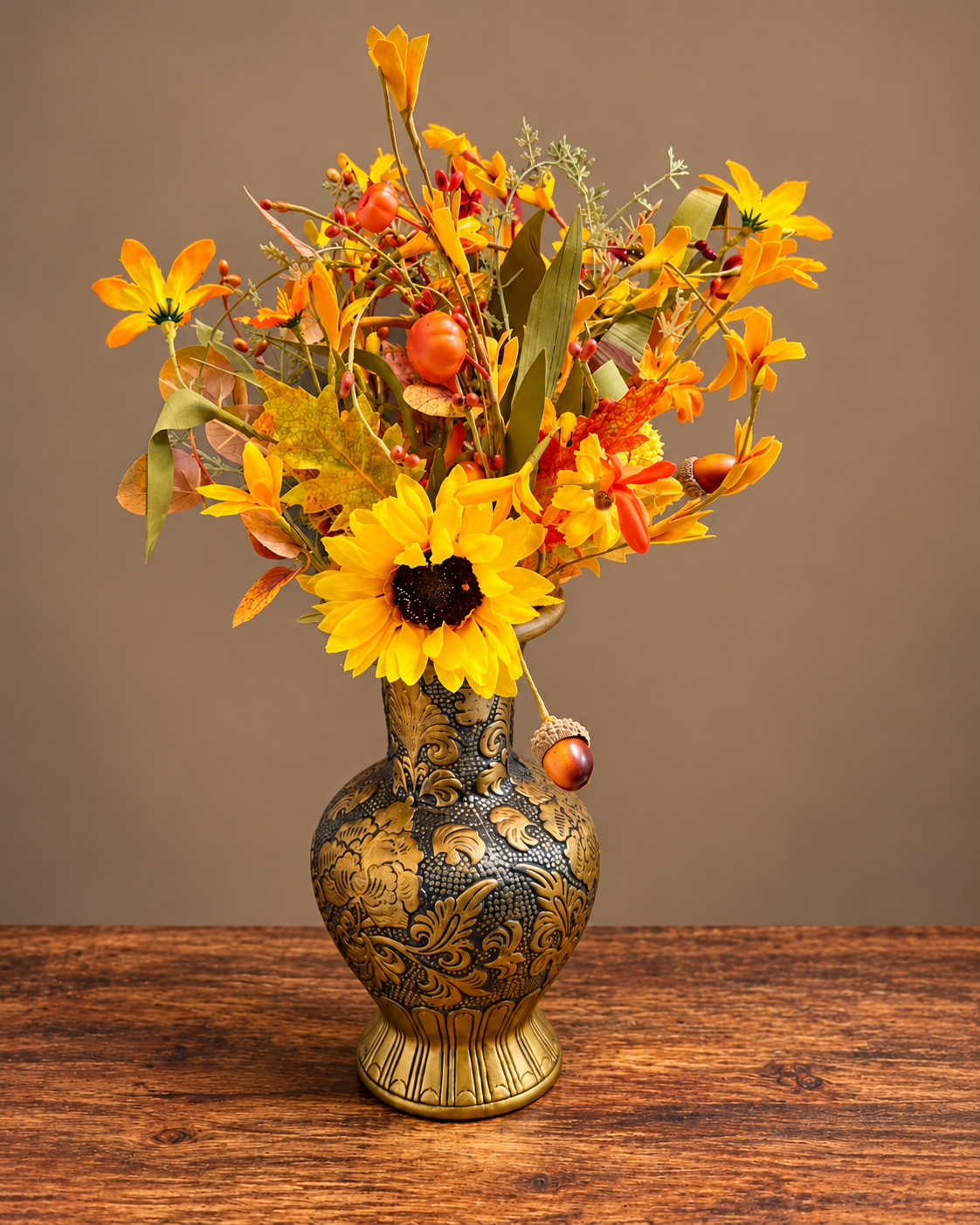 Autumn flowers with a sunflower in an ornate black and gold vase