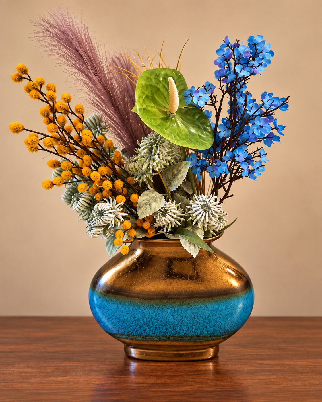 Blue and yellow flowers with greenery in a bronze and turquoise vase