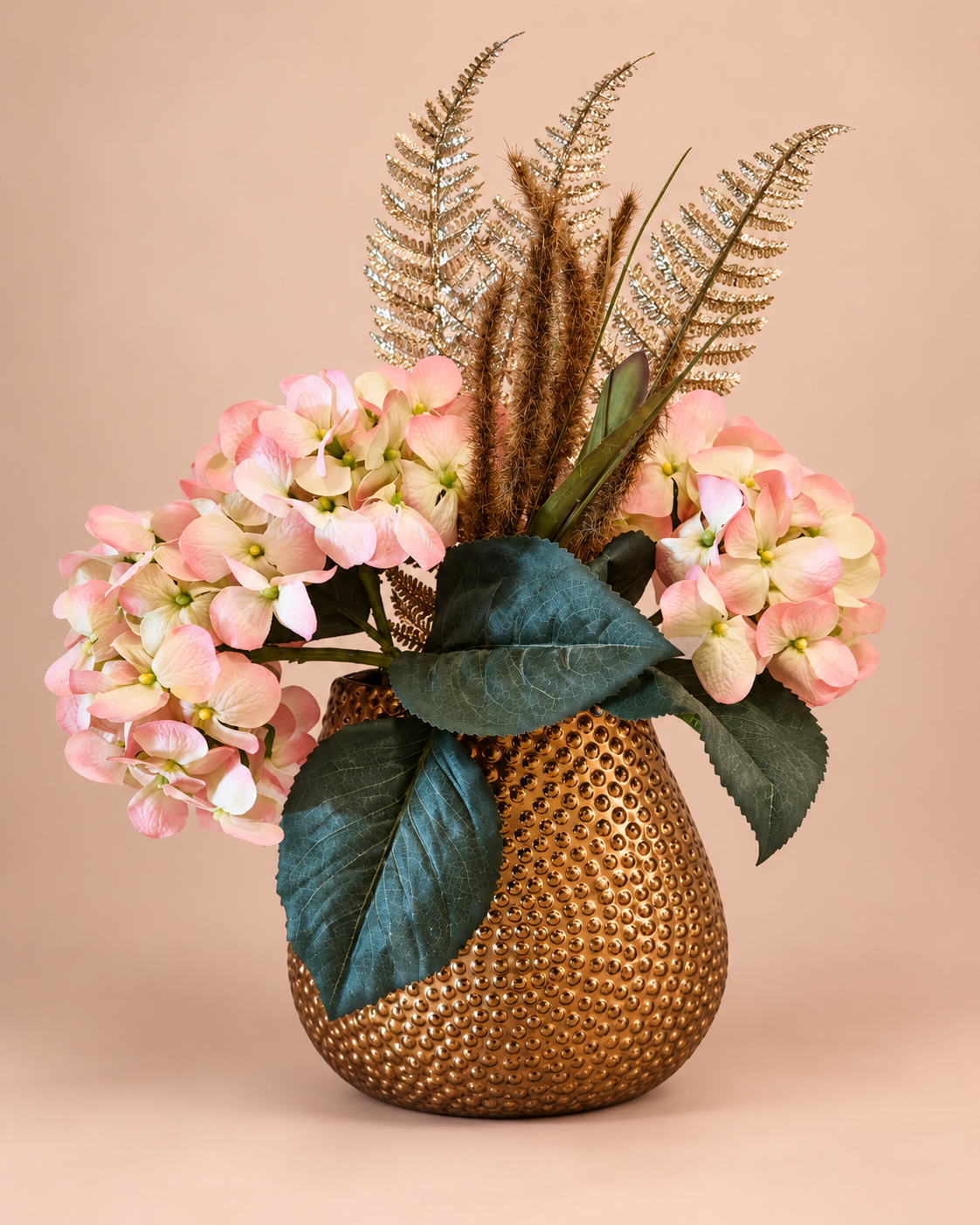 Pink hydrangeas and dried ferns in a textured brown vase