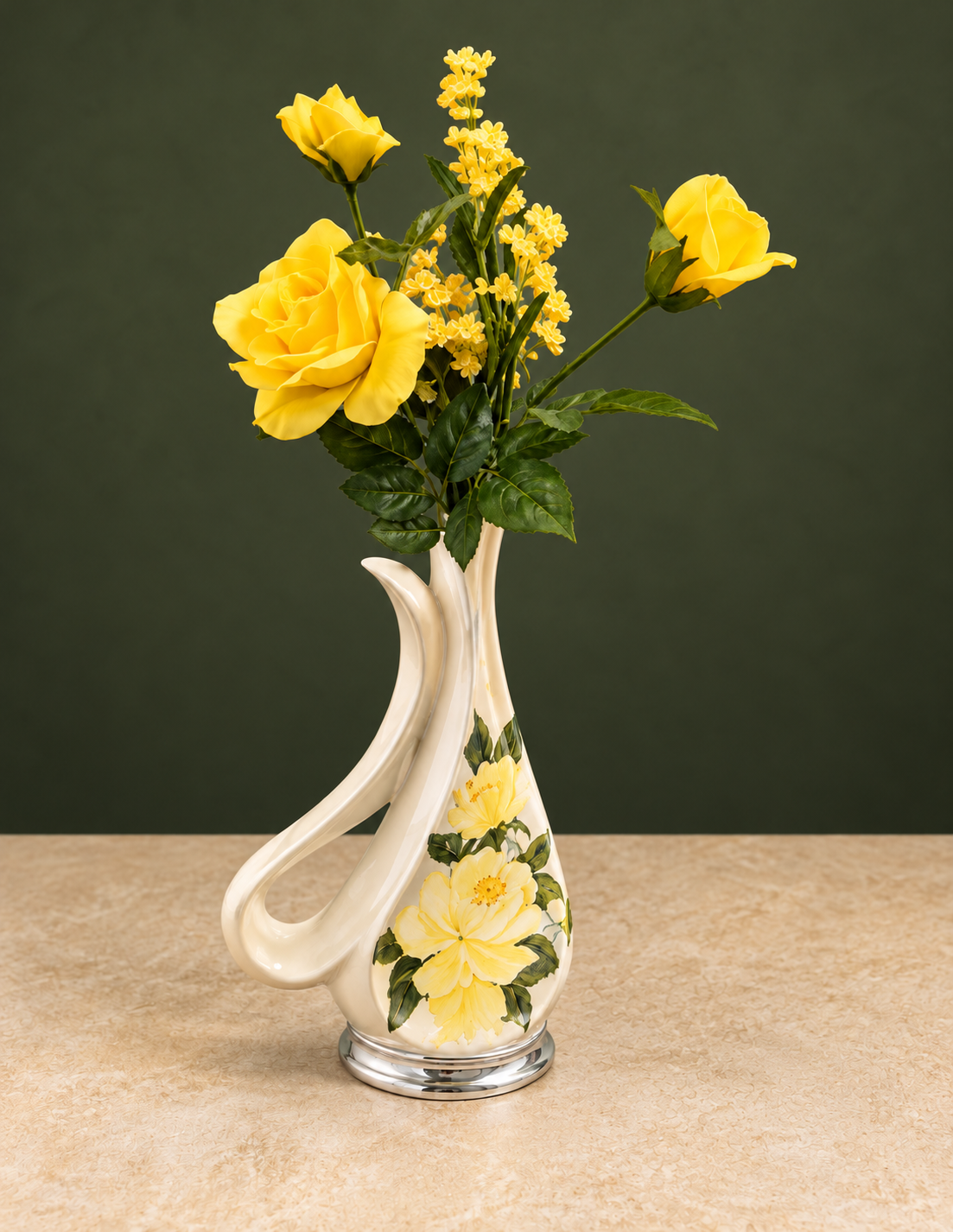 Bright yellow roses in a curved cream vase painted with yellow flowers against a dark olive-green background, on a clear beige tabletop